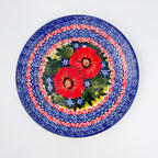 UNIKAT Red Finesy plate, top-down view of full plate showing red poppy cluster and scroll border