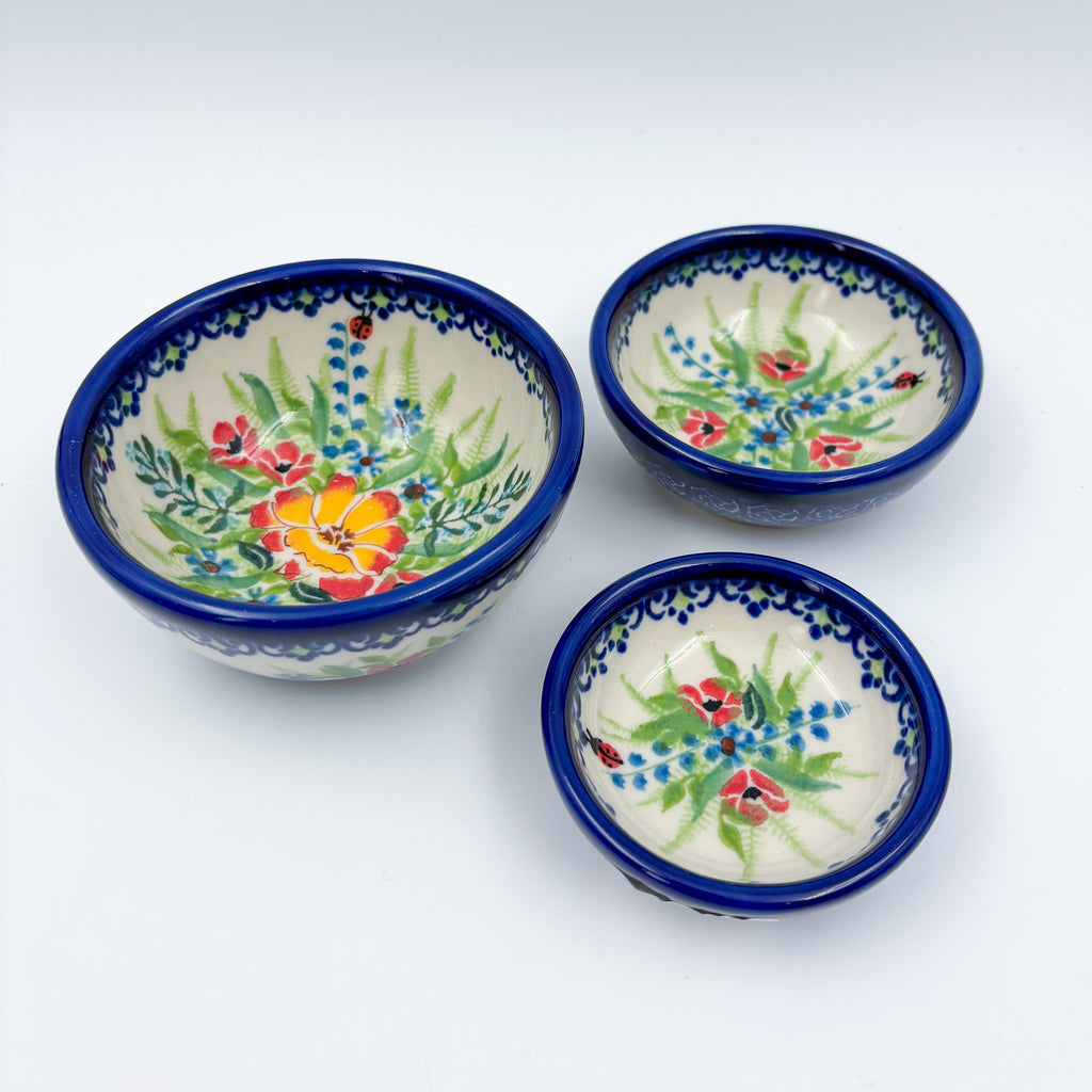 Ladybug Fields stacking bowl set, angled top-down view of all three bowls