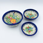 Ladybug Fields stacking bowl set, angled top-down view of all three bowls