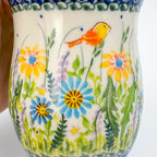 Close-up of Wildflower Meadow pattern on tulip mug showing painted songbird and flowers