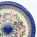 UNIKAT Happy Hydrangea plate, close-up rim view showing pink and purple hydrangea clusters