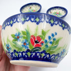 Close-up of largest Ladybug Fields bowl held in hand, showing poppy pattern