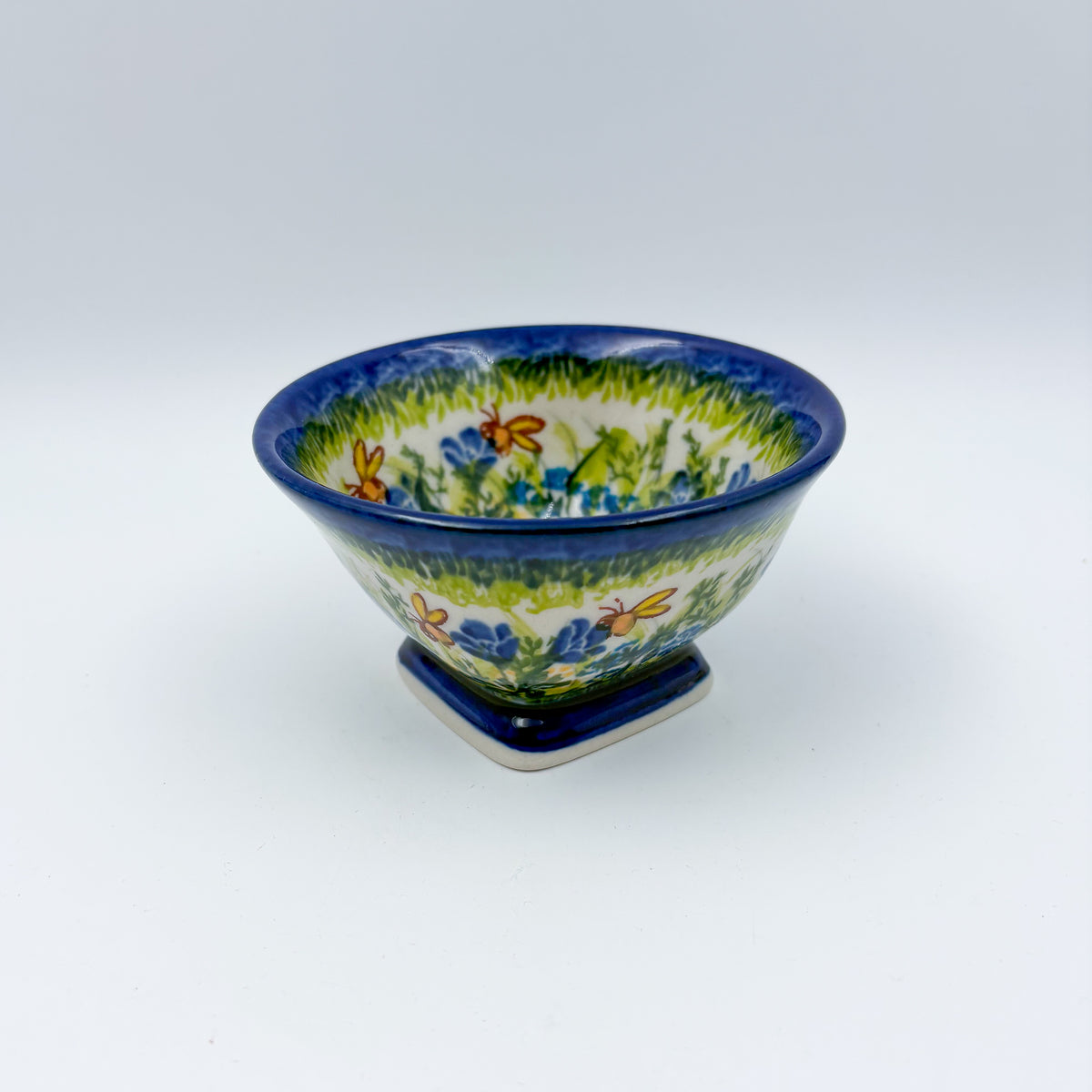 Bluebell Meadow small pedestal bowl, front view showing meadow band with bluebell flowers and butterflies
