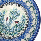 Close-up angled view of bullfinch birds inside Gracious Gonolek stacking bowl