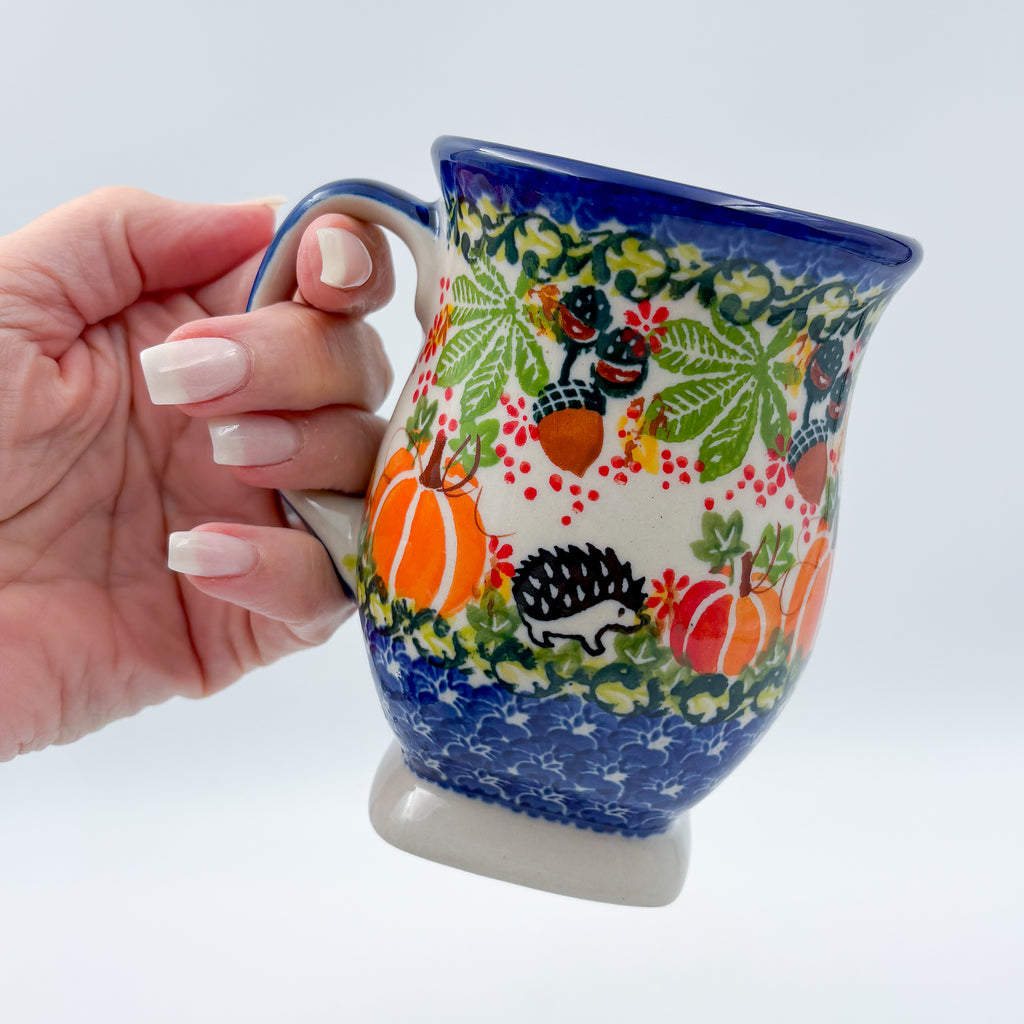 Hedgehog and Pumpkins tulip mug held in hand, front view