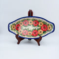 Garden Wreath boat platter with handles, front view on stand showing red and orange flower wreath