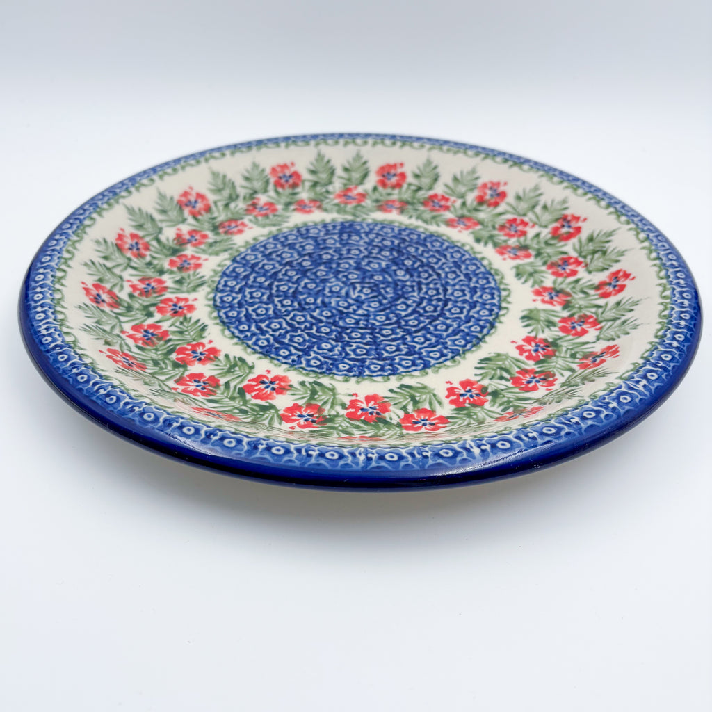 Midsummer Bloom plate, angled front view showing red flower ring around blue mosaic center
