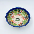 UNIKAT Hedgehog and Pumpkin scalloped bowl, top-down view showing hedgehog center with autumn leaf and acorn border