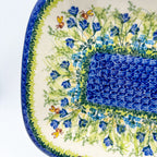 UNIKAT Bluebell Meadow large Daria platter, close-up corner view of bluebells, bees, and mosaic center