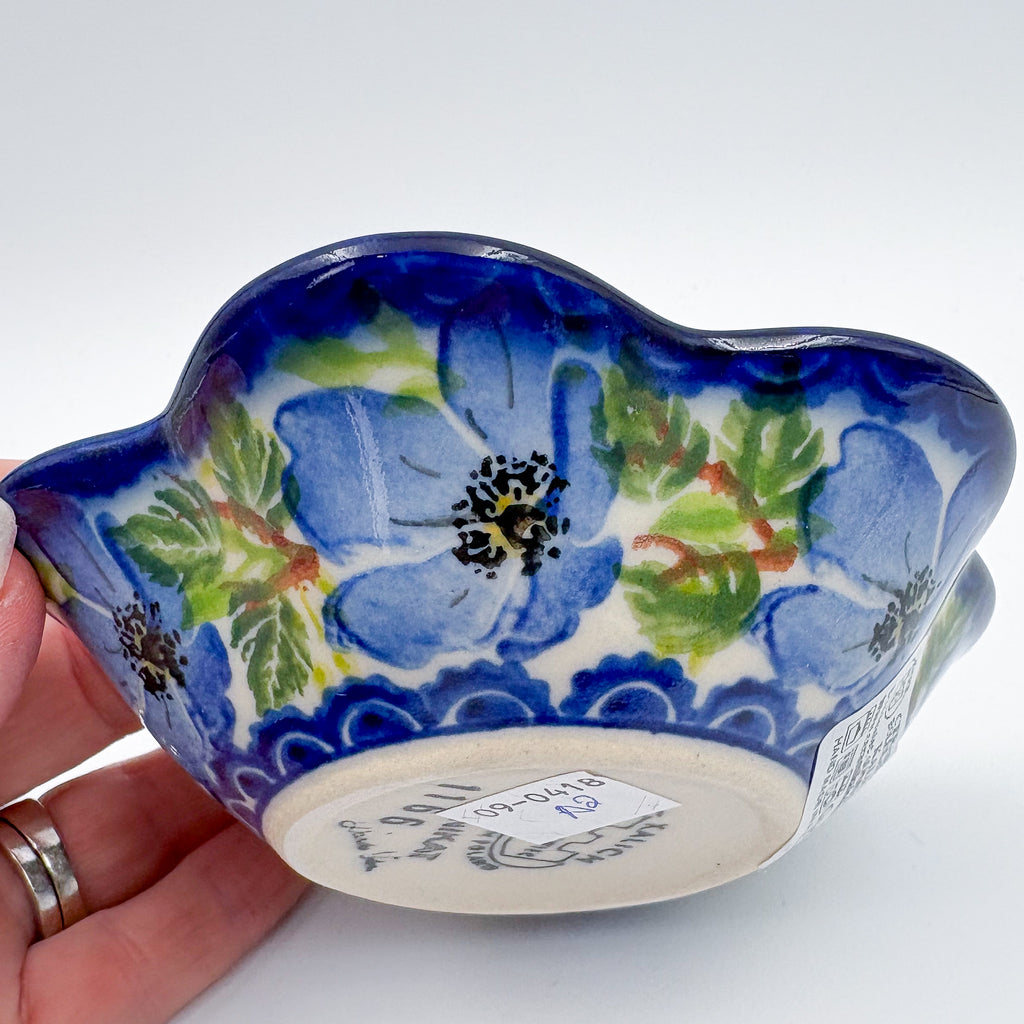 Bottom of Blue Poppy Songbird flower-shaped bowl, held in hand