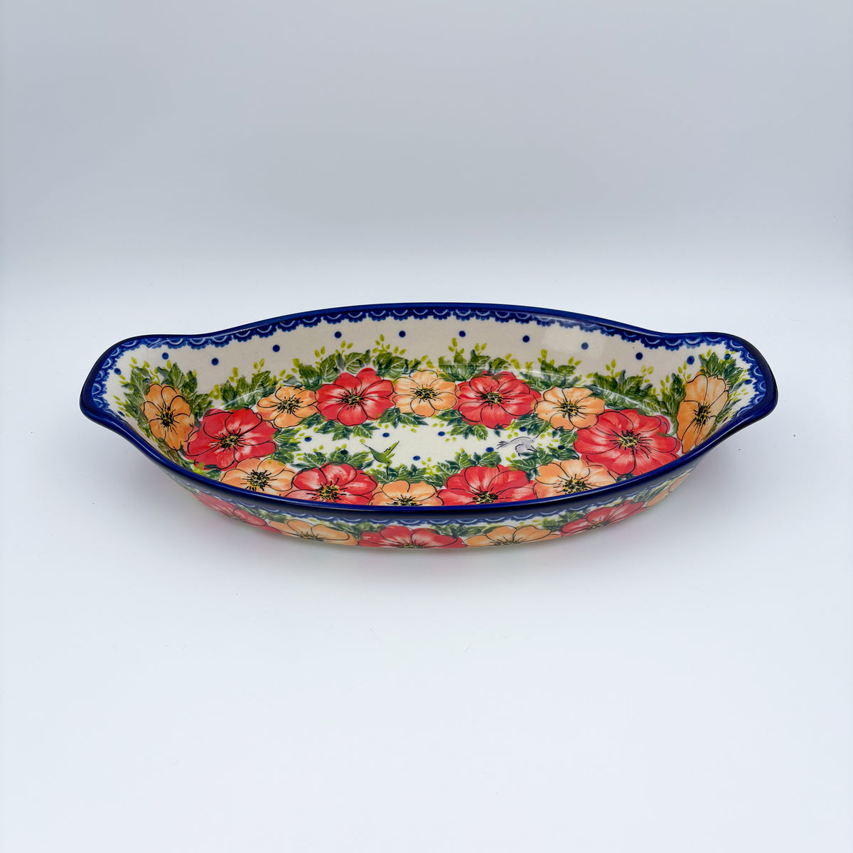 Garden Wreath boat platter, front view showing red and orange flower wreath and pointed handles
