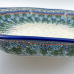 UNIKAT Whispering Ferns Clover platter, close-up exterior side view showing rose scroll rim and blue dotted interior