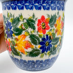 Close-up of autumn leaf and floral pattern on Fall Colors Viking mug, held in hand