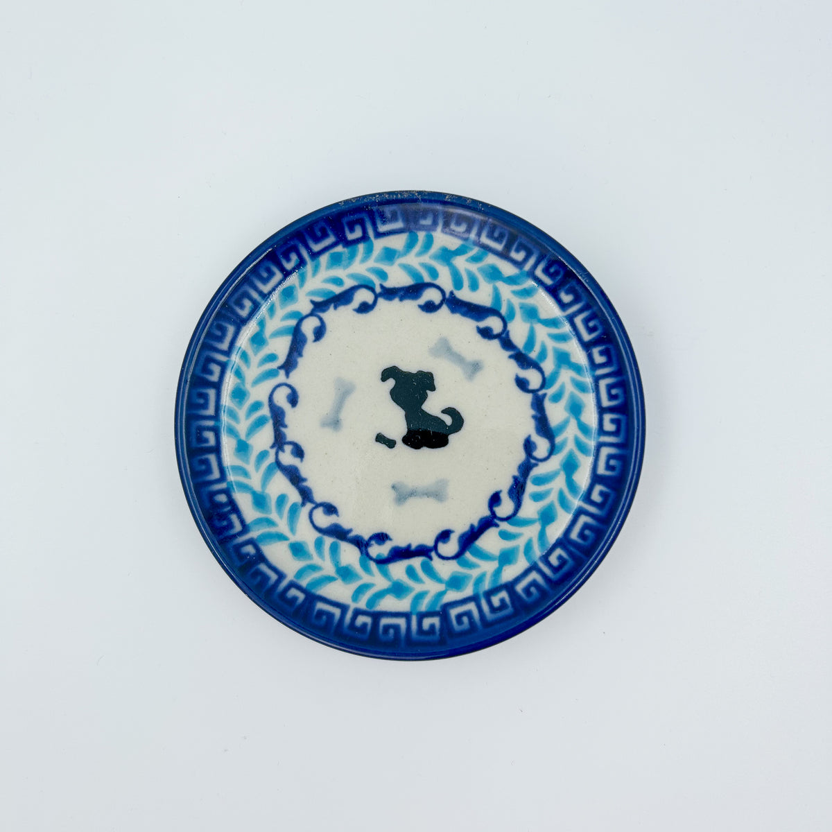 Puppy Plate, top-down view showing silhouette dog and bones on Greek key and vine border
