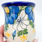 Close-up of Blue Petal Dance floral pattern, held in hand