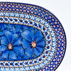 Cobalt Poppies oval platter, close-up end view of blue poppy flowers and multi-ring mosaic border