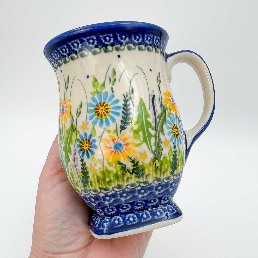 Wildflower Meadow tulip mug held in hand, angled front view