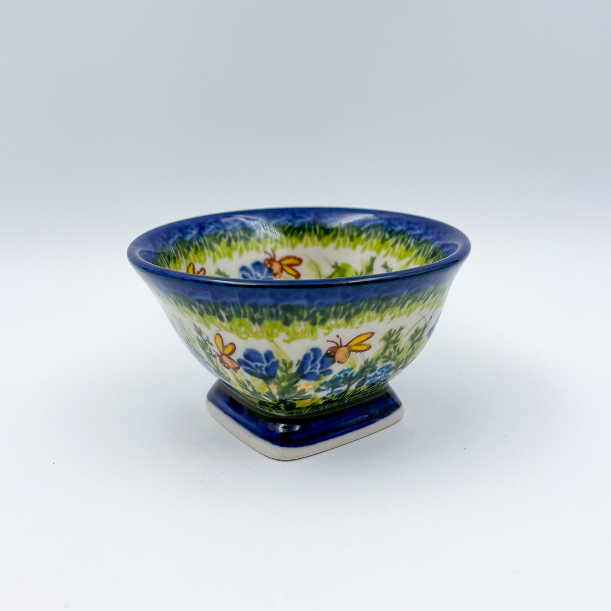 Bluebell Meadow small pedestal bowl, front view on pedestal foot showing bluebell and butterfly pattern