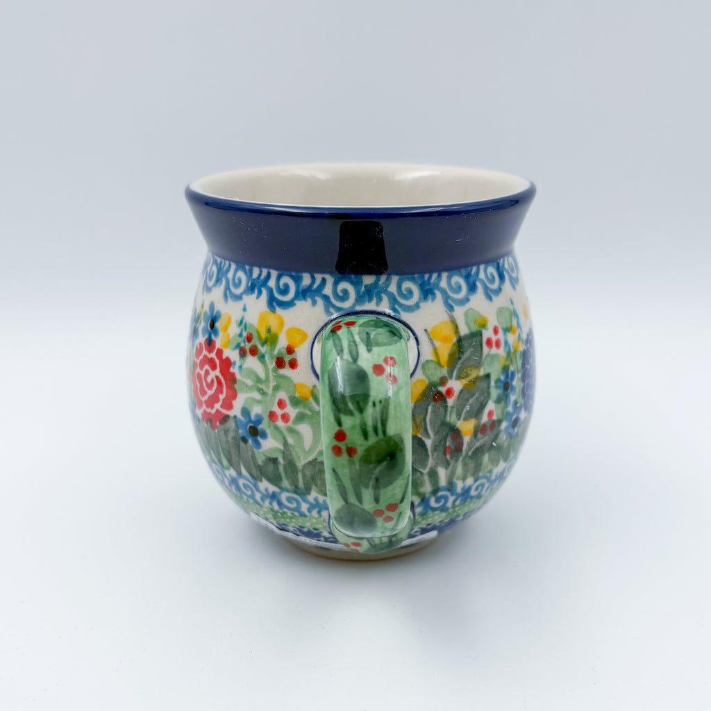 Butterfly Garden bubble mug on white background, angled view with green handle