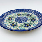 UNIKAT Blue Floral Day plate, angled front view showing blue flower ring around mosaic center