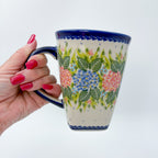 Hydrangea Fields mug held in hand, front view