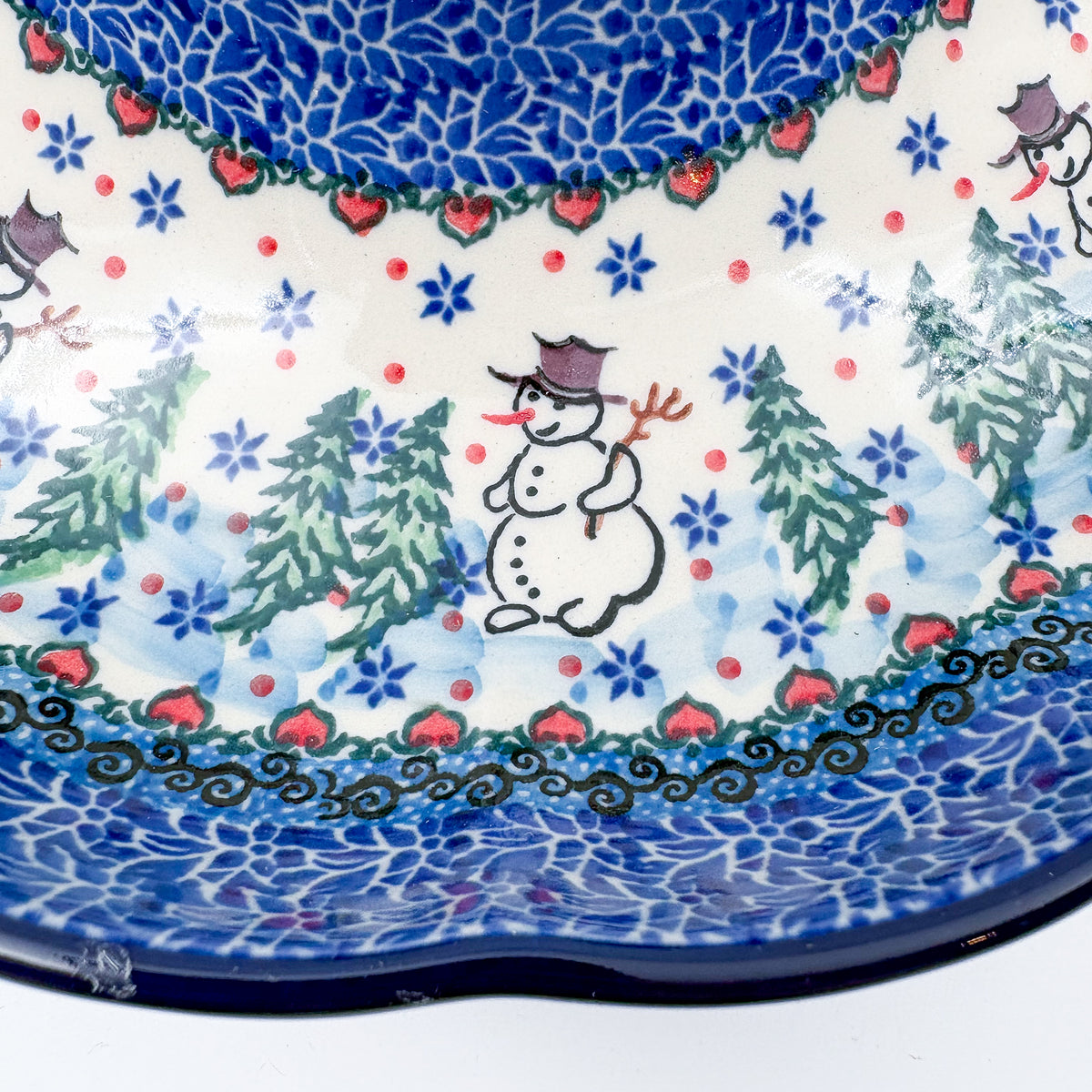 Dancing Snowman chip and dip platter, close-up of snowman with top hat between pine trees on outer ring