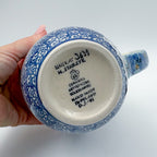 Bottom of Deep Winter latte mug showing Unikat stamp, alternate angle, held in hand