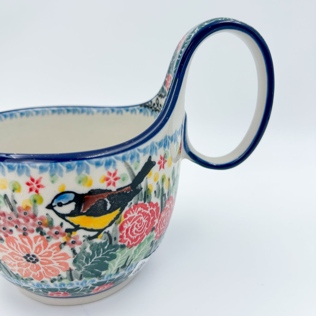 Polish pottery 16oz bowl with loop handle in the UNIKAT Robbin's Meadow pattern. 16 ounces of fluid.
6.26" x 4.49" x 5.51"
Ceramika Artystyczna Company