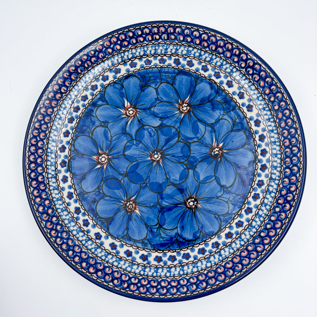 UNIKAT Cobalt Poppies plate, top-down view of full plate showing blue poppy center and scalloped border