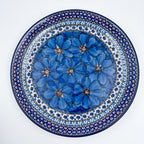 UNIKAT Cobalt Poppies plate, top-down view of full plate showing blue poppy center and scalloped border