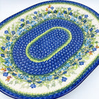 UNIKAT Bluebell Meadow XL oval platter, angled top-down view showing full bluebell mosaic rings and bee accents