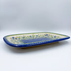 UNIKAT Bluebell Meadow large Daria platter, low-angle front view showing bluebell field and mosaic center