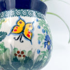 Close-up of painted butterfly on Spring Garden bubble mug