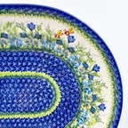 UNIKAT Bluebell Meadow XL oval platter, close-up corner view of bluebells, bees, and layered mosaic rings