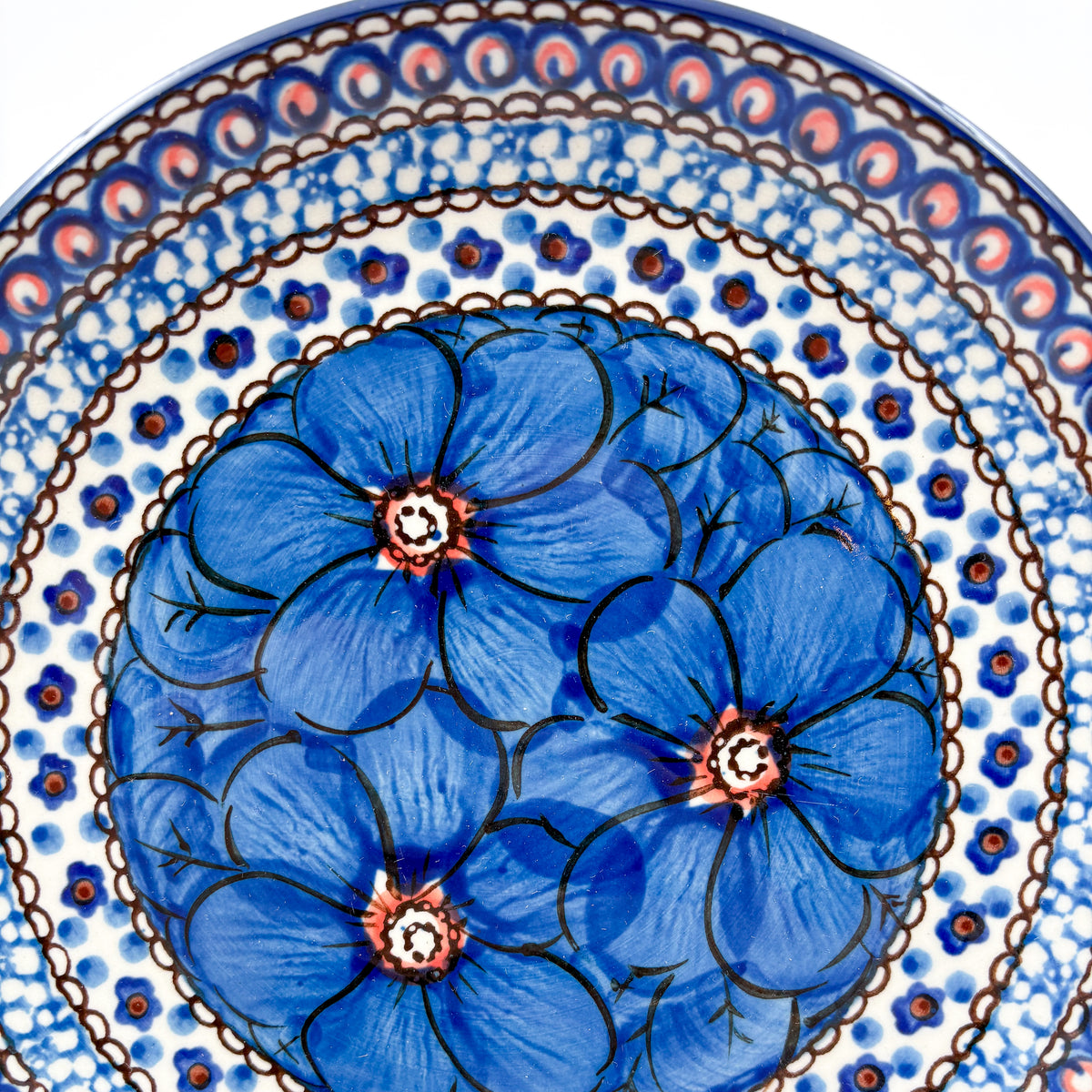UNIKAT Cobalt Poppies dessert plate, close-up top-down view of blue poppy cluster and scale border