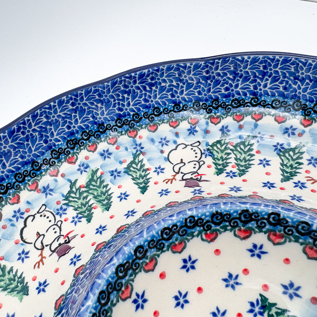 Dancing Snowman chip and dip platter, close-up rim detail showing snowmen dancing among pine trees and heart border