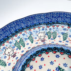 Dancing Snowman chip and dip platter, close-up rim detail showing snowmen dancing among pine trees and heart border