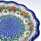 Close-up angled view of medallion and rim on Cottage Garden Kora bowl