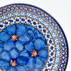UNIKAT Cobalt Poppies dessert plate, close-up rim view showing blue poppy petals and scale border