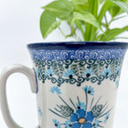 Close-up front view of Forget Me Not bistro mug showing handle and floral pattern