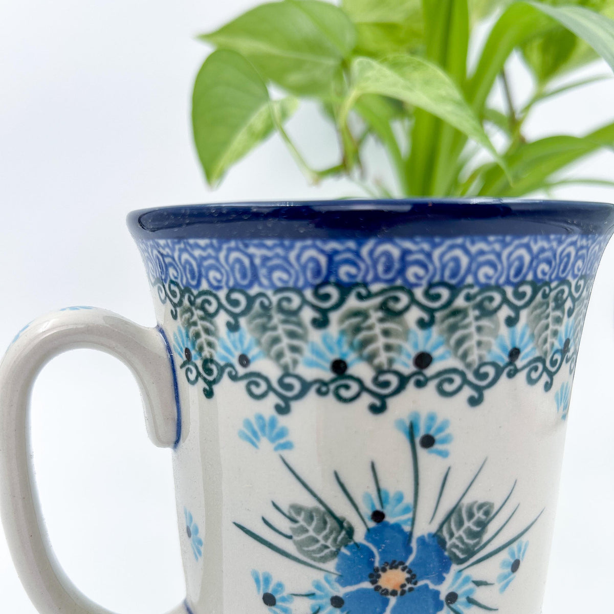 Close-up front view of Forget Me Not bistro mug showing handle and floral pattern