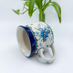 Forget Me Not bubble mug tipped on its side showing interior and handle