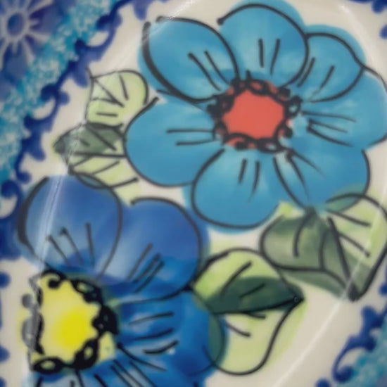 This 5” blue floral spoon rest is a handmade by talented Polish artisans. This is a Polish UNIKAT Bold Blue Poppies pattern 
Dimensions 5” x 3.54"
Ceramika BonaCompany