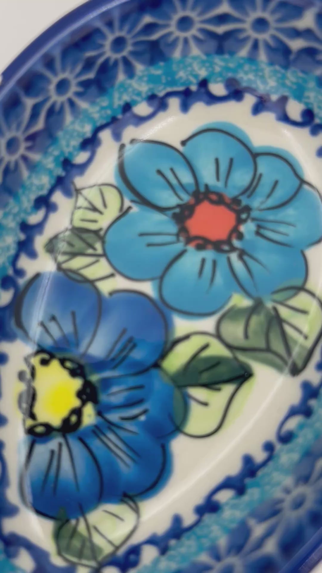 This 5” blue floral spoon rest is a handmade by talented Polish artisans. This is a Polish UNIKAT Bold Blue Poppies pattern 
Dimensions 5” x 3.54"
Ceramika BonaCompany