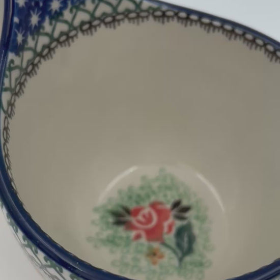 Polish pottery 16oz floral bowl with loop handle in the UNIKAT Sweet Leilani pattern. This Polish Pottery bowl is made by talented artisans from Poland.  16 oz of fluid.
6.26" x 4.49" x 5.51"
Ceramika Artystyczna Company