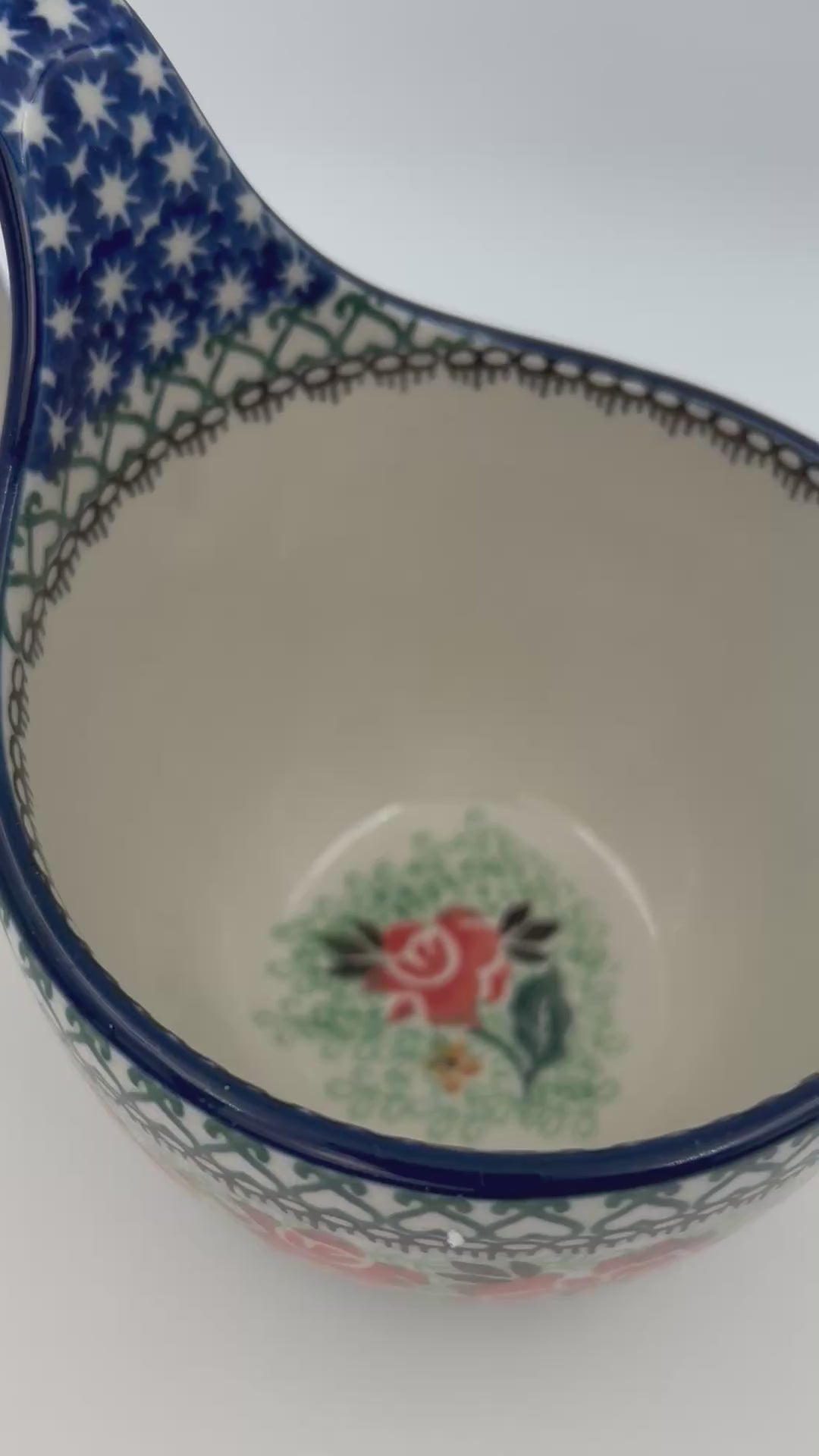 Polish pottery 16oz floral bowl with loop handle in the UNIKAT Sweet Leilani pattern. This Polish Pottery bowl is made by talented artisans from Poland.  16 oz of fluid.
6.26" x 4.49" x 5.51"
Ceramika Artystyczna Company